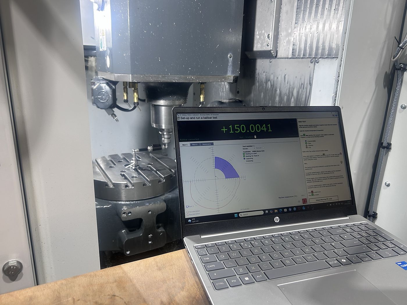 Ballbar test running on a CNC machining centre, with the live plot on a laptop