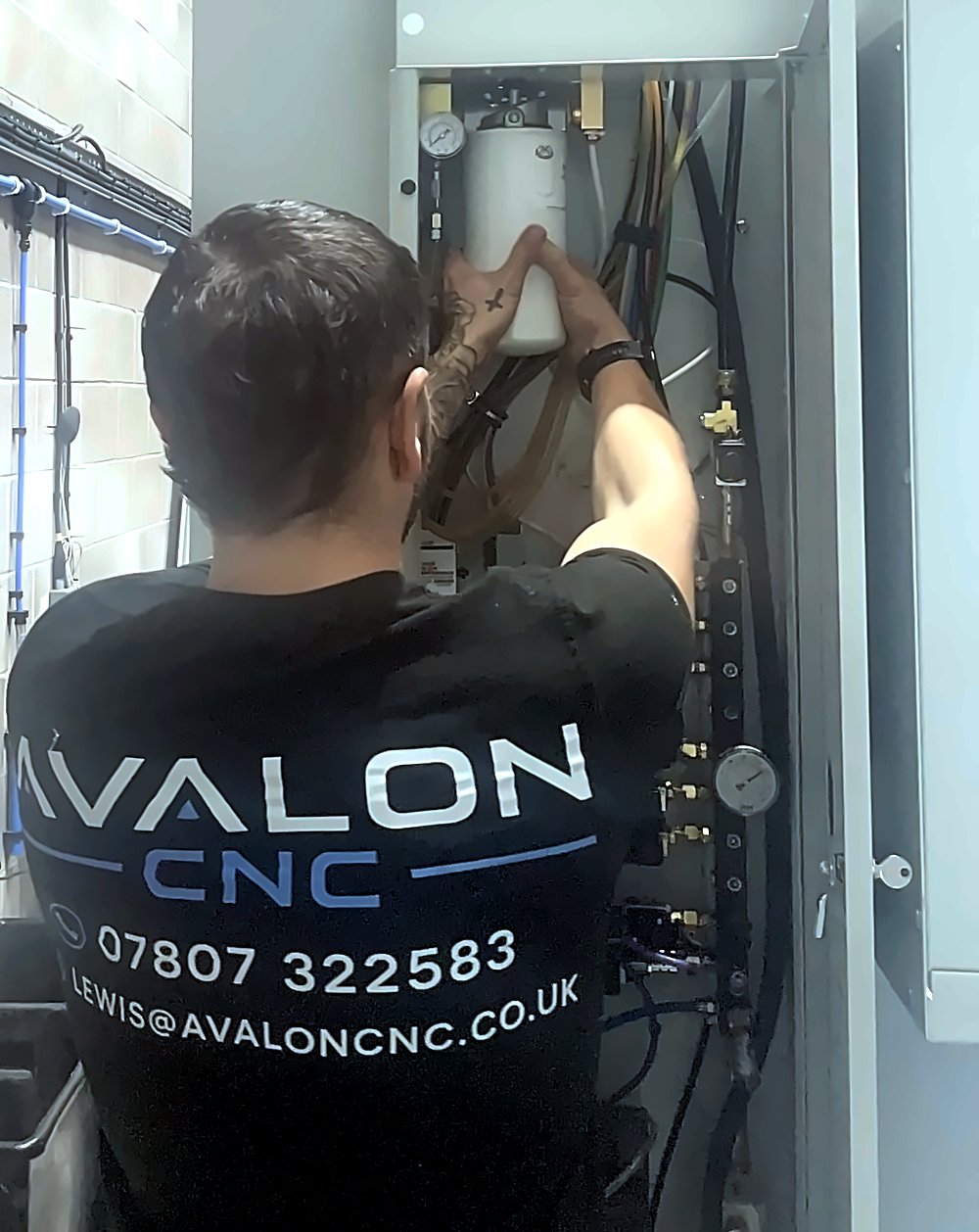 AvalonCNC engineer removing the axis lube oil canister on a CNC machine