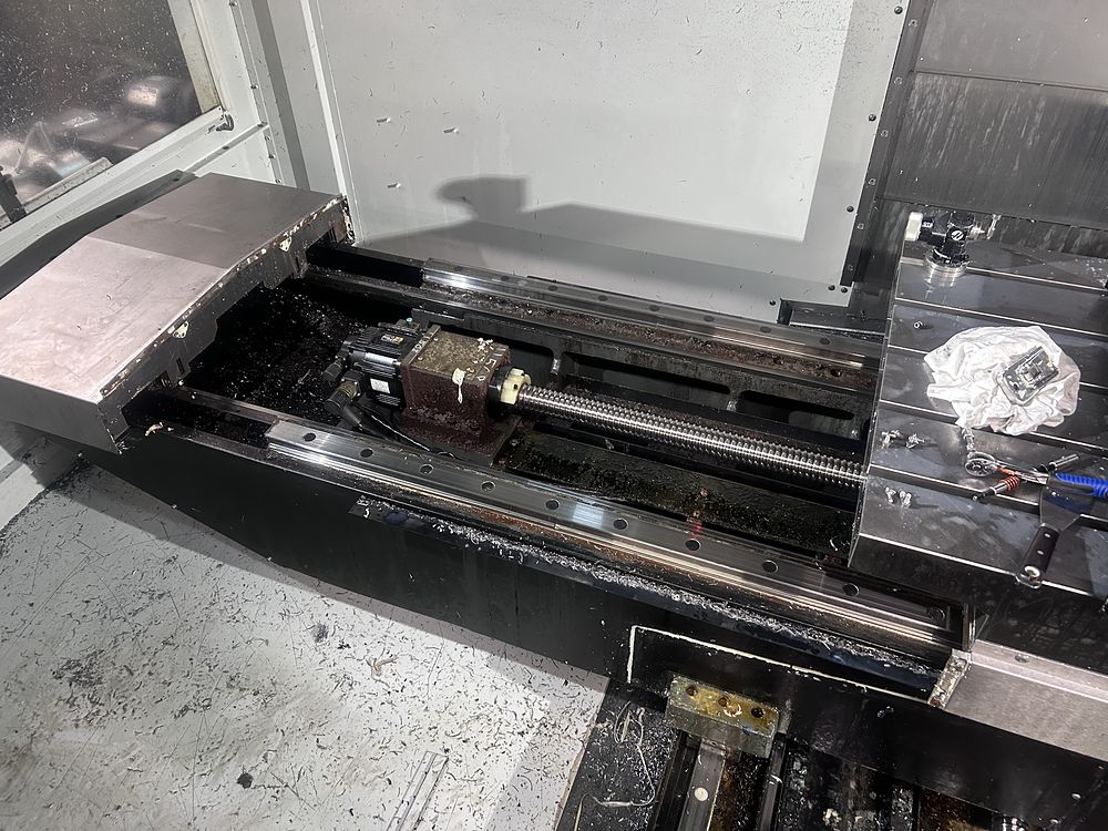X-axis ballscrew, servo motor and linear guides exposed for cleaning